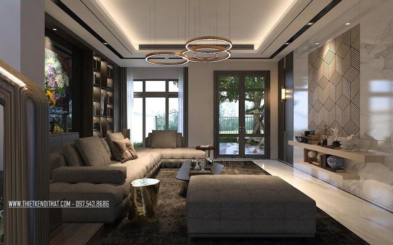 Bố trí nội thất phòng khách ấn tượng với cách kết hợp hài hòa giữa sắc trầm và sáng cùng hệ cửa kính lớn giúp không gian trở nên thông thoáng, sang trọng.